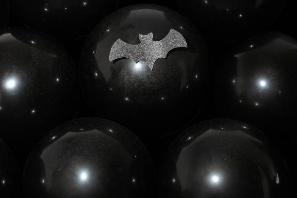 Black balloons with water drops and cutout bat Halloween sale party background