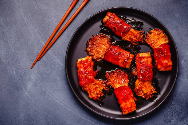 istock Bacon roll with enoki mushroom grilled with sauce. 2170058032