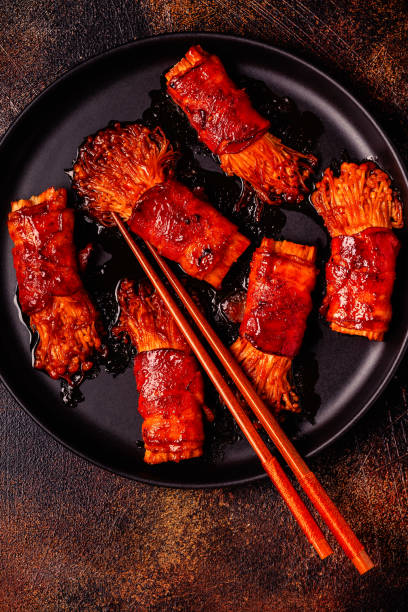 istock Bacon roll with enoki mushroom grilled with sauce. 2170058593
