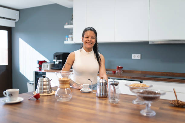 istock Woman smiling and looking at camera in kitchen 2170059214