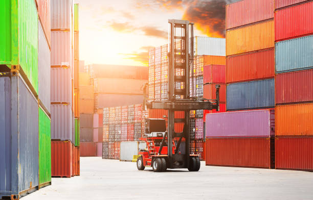 istock Container Crane Tractor Lifting up Container Box at Warehouse Port. Handling of Logistics Transportation Industry. Cargo Container ships, Freight Truck Import-Export. Distribution Warehouse Shipping. 2170060259
