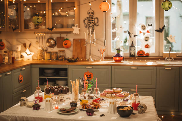 Food table filled with different type of food and drinks ready for Halloween party