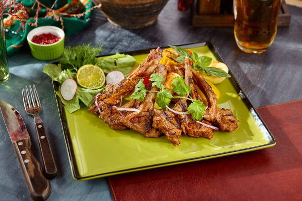 istock Grilled Lamb Chops with Fresh Vegetables on a Green Plate – Rustic Dining Experience 2170061916