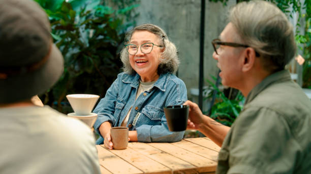 istock Group of old Asian people talking about old times while reuniting with each other at a coffee shop. 2170064220
