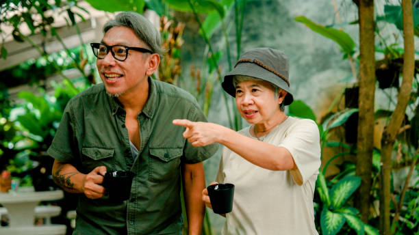 istock Group of retired Asian people looking around a beautiful cafe while reuniting with each other. 2170064420