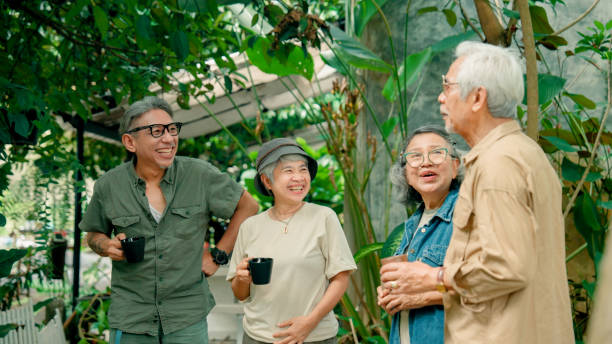 istock Group of retired Asian people looking around a beautiful cafe while reuniting with each other. 2170064422
