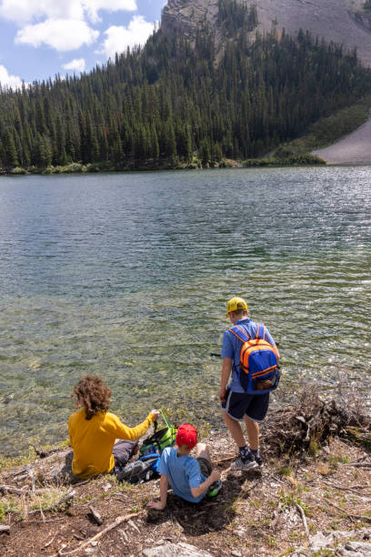 istock Brothers relax on lakeshore in mountains 2170065313