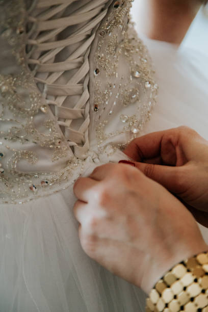 istock A bride adjusts a wedding dress 2170067468