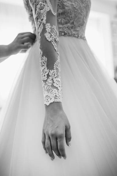 istock A bride adjusts a wedding dress 2170067495