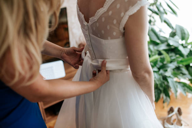 istock A bride adjusts a wedding dress 2170067615