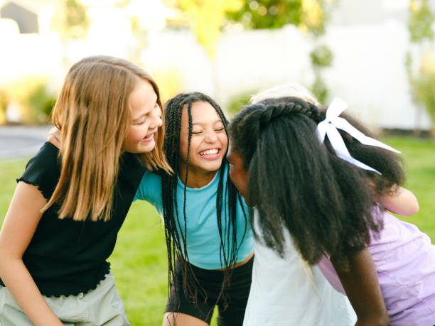 A group of young girls playing and having fun in a home backyard in summer.