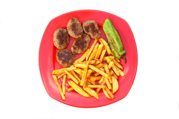 Floating plate with Burger and french fries  on red gradient background