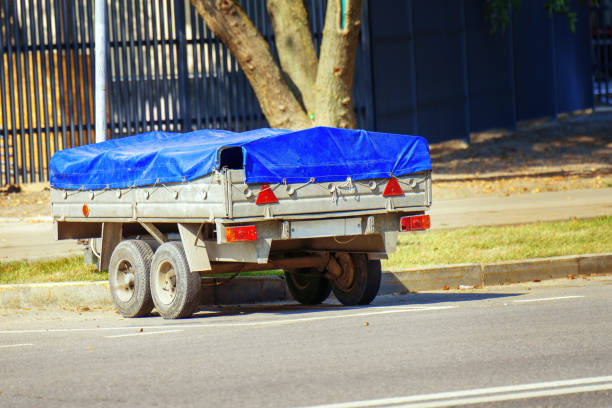 Car in motion carrying a small trailer