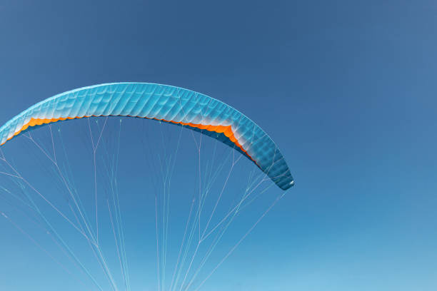 istock Colorful paraglider close-up against the blue sky 2170076109