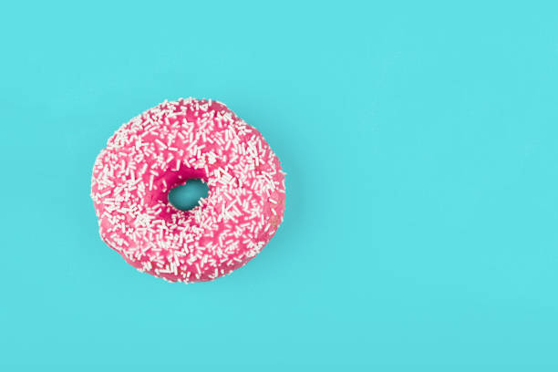 istock Pink donut on color background, flat lay, top view 2170077108
