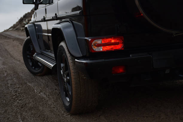 Kampinos, Poland - 2nd December, 2015: Details of Mercedes-Benz G500 on the unmade road and in the dark scenery. The G-Class was debut in 1978.