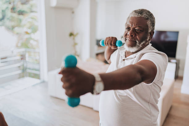 istock Elderly man exercising at home with dumbbell physiotherapy 2170084241