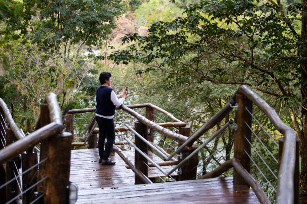 istock Lone woman on a wooden walkway 2170086703