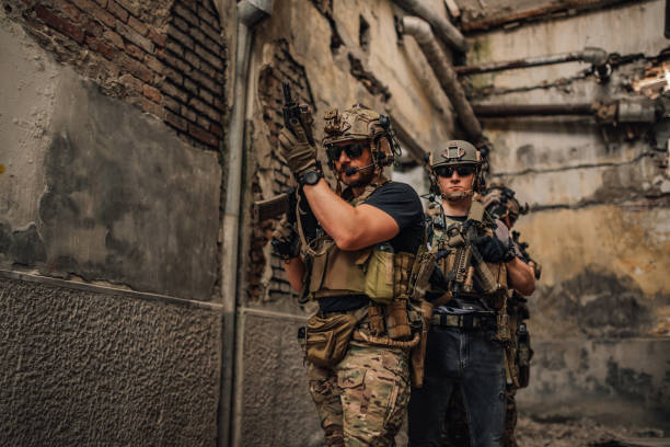 istock Group of air soft players with weapons going in a battle in crashed building 2170093199