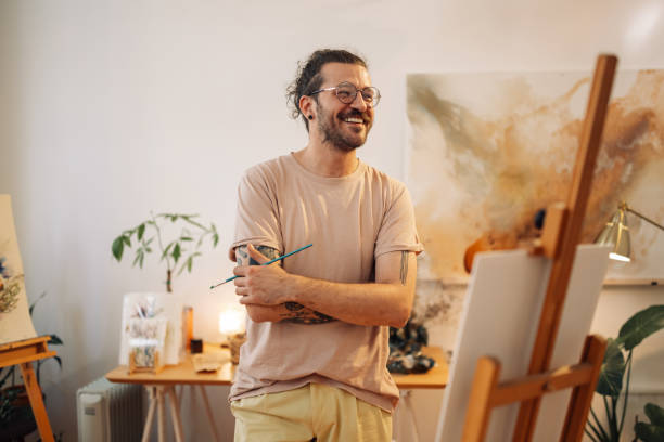 istock Young artistic confident artist standing with arms crossed at studio. 2170094032
