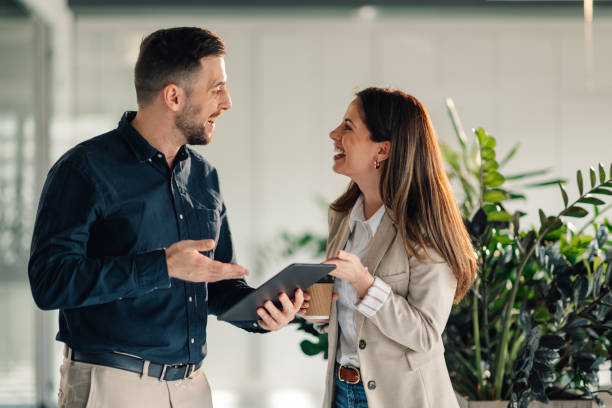 istock Smiling businesspeople with tablet collaborating on a start up project 2170094095