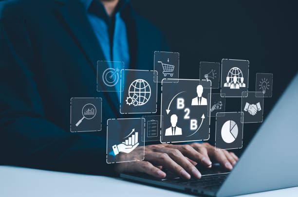 istock B2B business strategy concept. Businessman working with a B2B virtual interface on a laptop, conceptualizing strategy, partnership, targets in business to business services. E-commerce, B2B Marketing, 2170095484