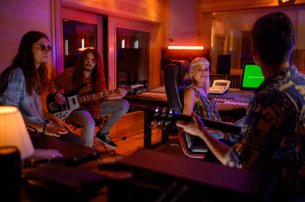 istock Professional musicians sitting in studio with sound engineer and making song 2170097707