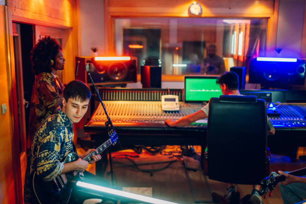 istock Interracial band recording a song at music recording studio. 2170097712