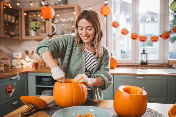 Woman carving pumpkin for Halloween