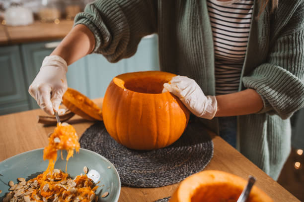 istock Woman carving pumpkin for Halloween 2170097828