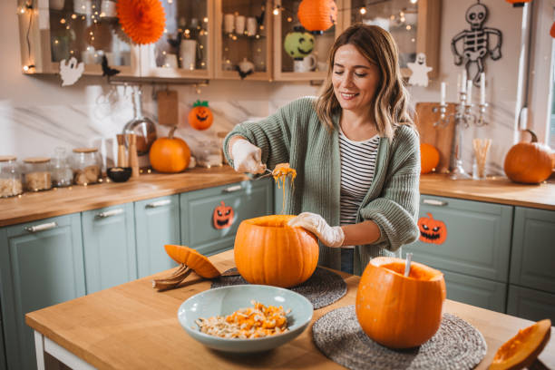 istock Woman carving pumpkin for Halloween 2170097830