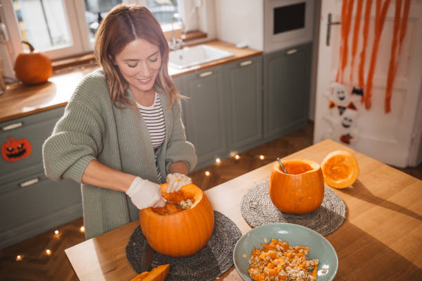istock Woman carving pumpkin for Halloween 2170097834