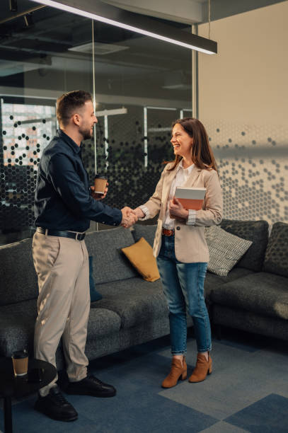 istock Business partners shaking hands and greeting at corporate office. 2170097877