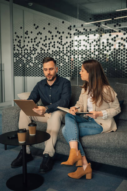 istock Elegant businesspeople brainstorming and collaborating on a project. 2170097883