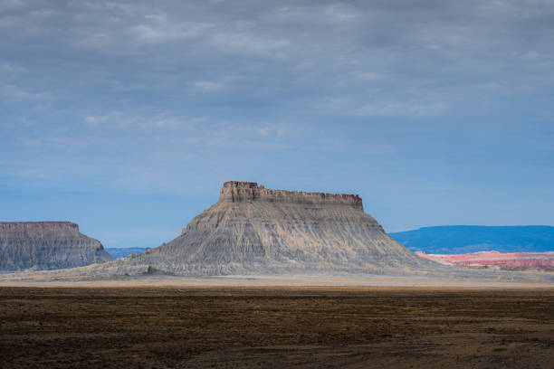 Factory Butte, massive ancient sandstone natural structure surrounding by incredible landscape in Hanksville, Utah.