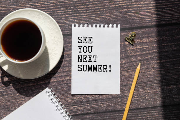 istock See you next Summer written on a note at the office table with empty space for text. 2170101986