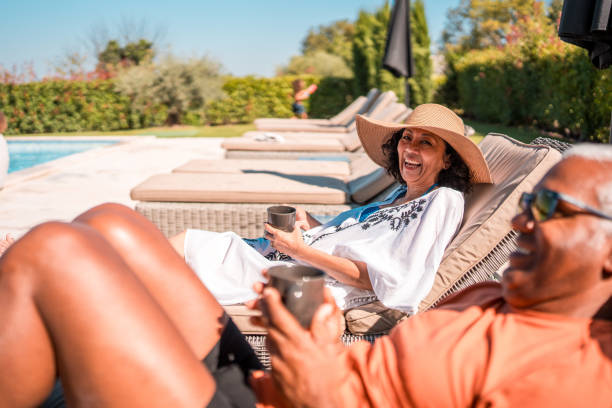 istock Hispanic Seniors on Deckchairs by the Pool 2170105735