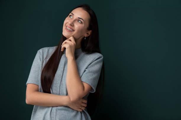 istock Woman Standing in Front of Green Wall 2170105762