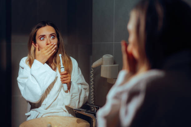 istock Woman Brushing her Teeth Feeling Pain and Sensitivity 2170106270
