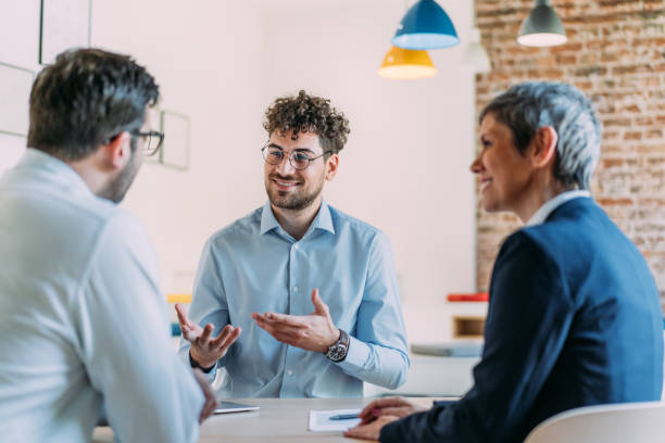 istock Group of business persons talking in the office. 2170109609