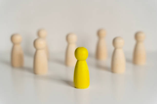 istock Stepping Out to be Different. Teamwork and Leadership Concepts with Wooden People Figures. 2170112942