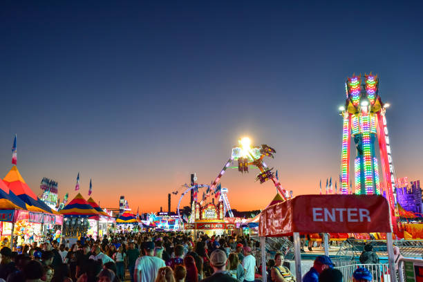 Silhouettes of carnival rides under sunset