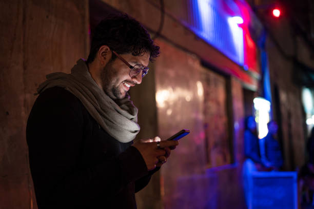 istock Young man using his smartphone to talk to his friends 2170116328