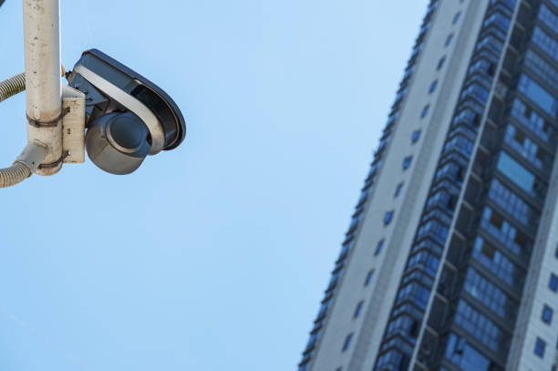istock Security camera and modern city building with blue sky background 2170116549