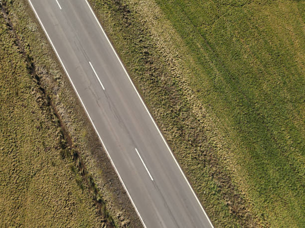 istock Road in the countryside in spring from above 2170117021