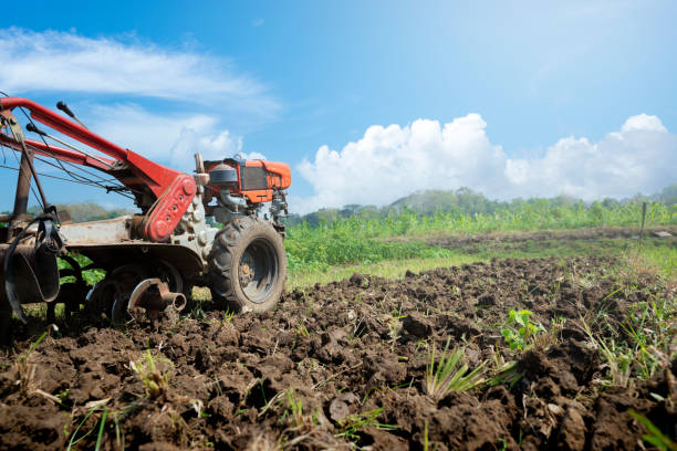 istock A tractor is working in a field with dirt and grass 2170117737