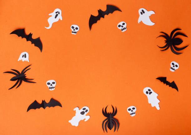 istock Halloween composition of spiders, bats, skulls and ghosts on orange background. 2170121096