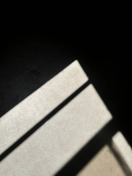 istock Light from the window. A sharp contrast of light and shadow from the window on the floor. The light falls from the window onto the dark floor. 2170122953