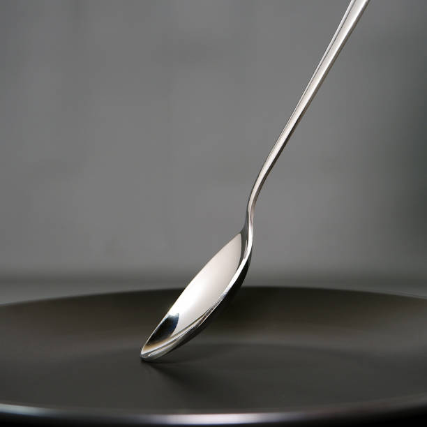 istock A teaspoon isolated over black ceramic plate with dark background close up view 2170125706