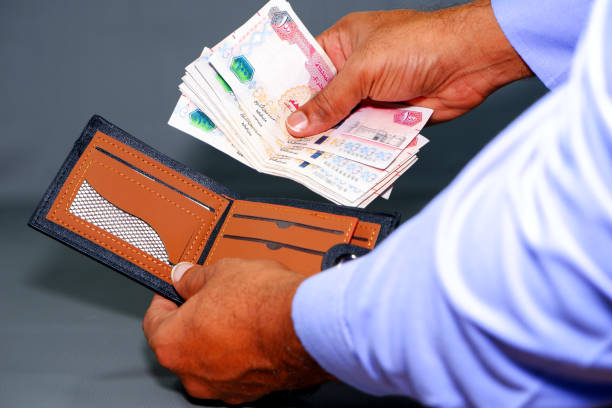 istock Hand holding currency notes with opening wallet close-up view 2170125893